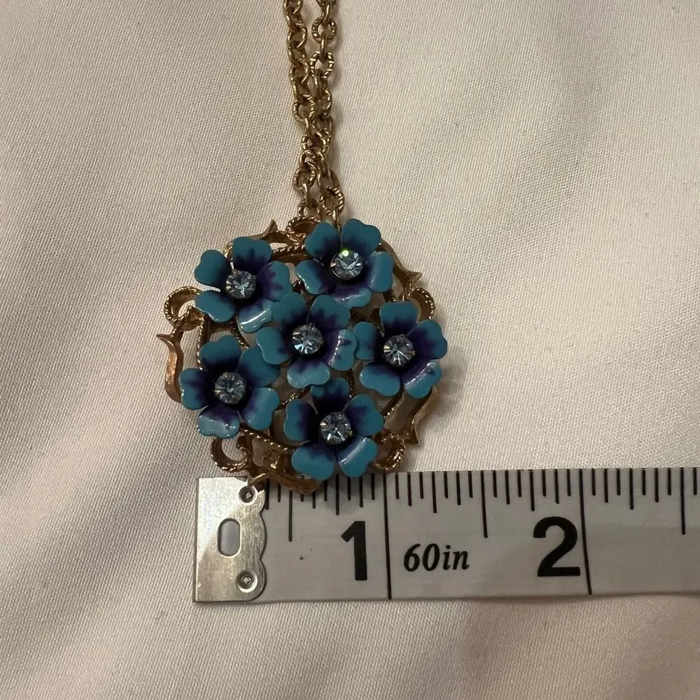 Vintage Avon blue flower pendant or broach on a gold colored chain EVC